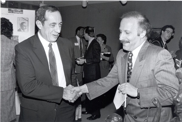 Peter Golden shakes hands with Governor Mario Cuomo